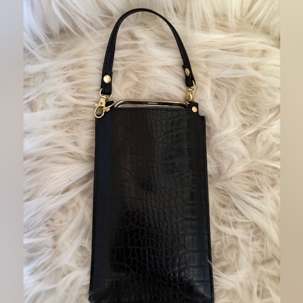 Cell phone wristlet with wallet in black crocodile leather like material.